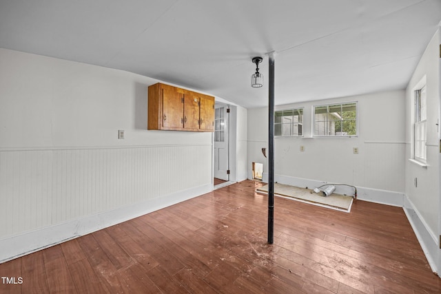 303 N Watauga Ave, Dunn, NC 28334 - unfurnished living room featuring hardwood / wood-style flooring, wainscoting, and baseboards