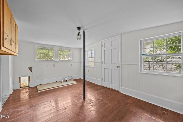 303 N Watauga Ave, Dunn, NC 28334 - unfurnished bedroom with wood-type flooring, baseboards, and wainscoting