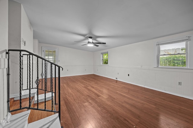303 N Watauga Ave, Dunn, NC 28334 - unfurnished room featuring wood finished floors, a ceiling fan, and stairway