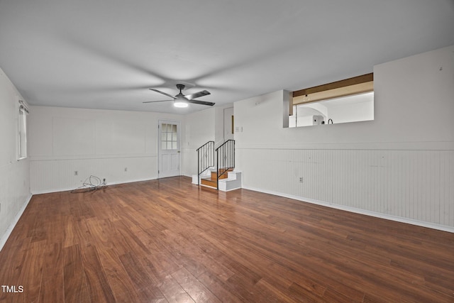 303 N Watauga Ave, Dunn, NC 28334 - unfurnished living room with hardwood / wood-style floors, stairs, a ceiling fan, and baseboards