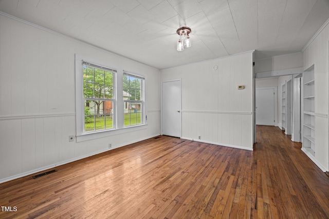 303 N Watauga Ave, Dunn, NC 28334 - unfurnished bedroom featuring crown molding and hardwood / wood-style flooring