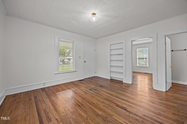 303 N Watauga Ave, Dunn, NC 28334 - unfurnished bedroom with wood finished floors and baseboards