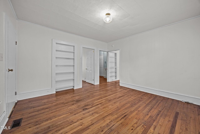 303 N Watauga Ave, Dunn, NC 28334 - unfurnished bedroom with hardwood / wood-style flooring and baseboards