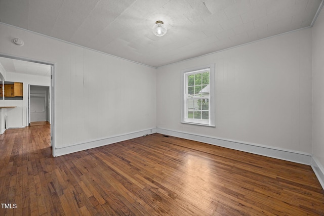 303 N Watauga Ave, Dunn, NC 28334 - unfurnished room featuring wood-type flooring, baseboards, and a smoke detector