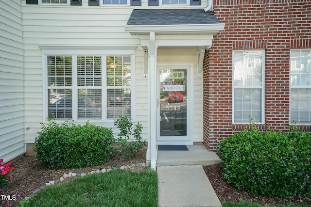 entrance to property with brick siding
