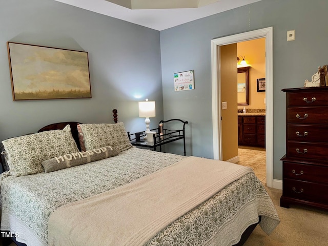 327 Beavertail Rd, Henderson, NC 27537 - bedroom with light colored carpet, connected bathroom, and baseboards