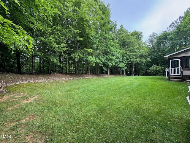 327 Beavertail Rd, Henderson, NC 27537 - view of grassy yard with a wooded view