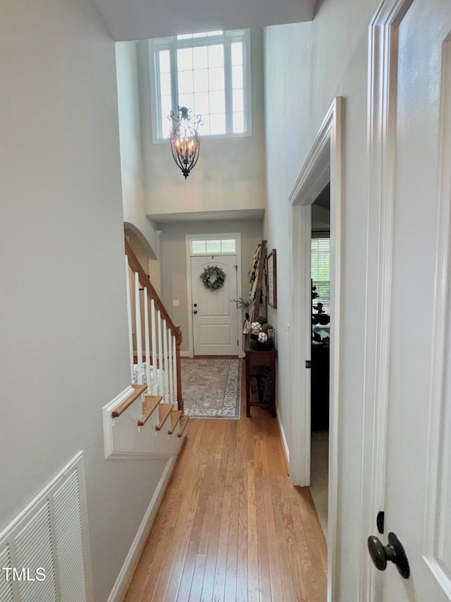 327 Beavertail Rd, Henderson, NC 27537 - entrance foyer with light wood-type flooring, plenty of natural light, a chandelier, baseboards, and a high ceiling