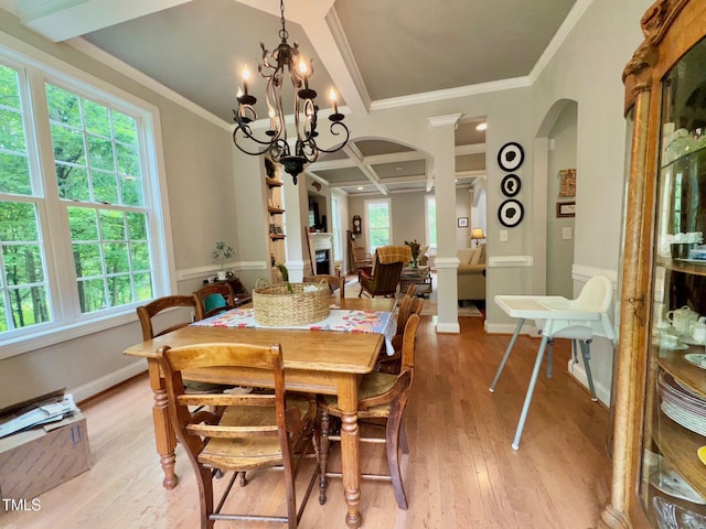 327 Beavertail Rd, Henderson, NC 27537 - dining room with arched walkways, light wood-style flooring, coffered ceiling, a chandelier, and crown molding