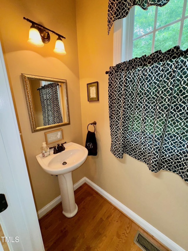327 Beavertail Rd, Henderson, NC 27537 - bathroom with wood finished floors, baseboards, and a sink