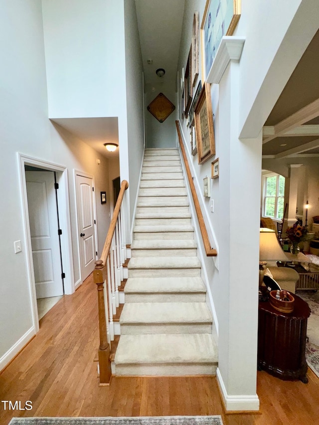 327 Beavertail Rd, Henderson, NC 27537 - stairs featuring wood finished floors, a high ceiling, and baseboards