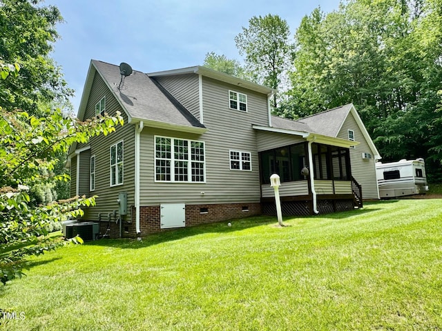 327 Beavertail Rd, Henderson, NC 27537 - rear view of house with a sunroom, a yard, a shingled roof, and central AC