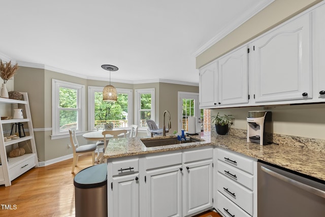 kitchen with dishwasher, a sink, a peninsula, white cabinetry, and light wood-style flooring