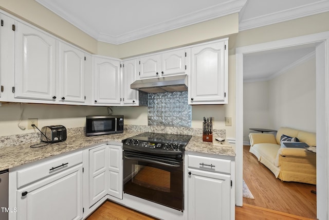 kitchen featuring black / electric stove, under cabinet range hood, ornamental molding, light wood-style flooring, and white cabinetry