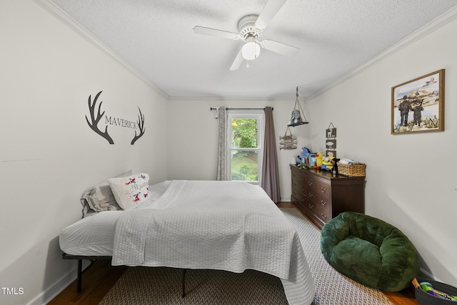 bedroom with crown molding, wood finished floors, a textured ceiling, a ceiling fan, and baseboards