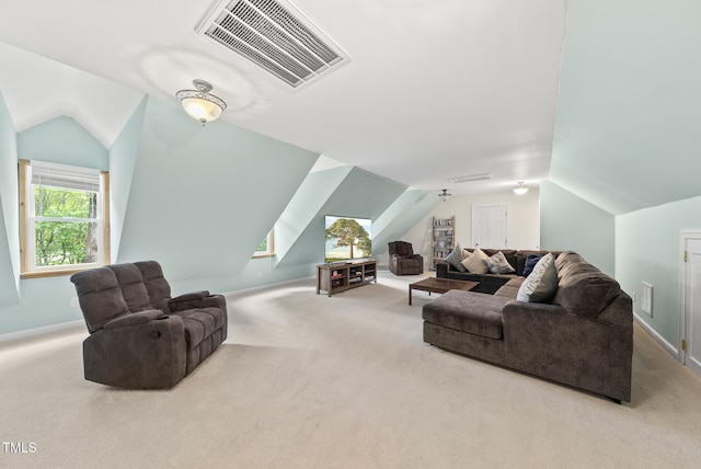 living area featuring lofted ceiling, carpet floors, and baseboards