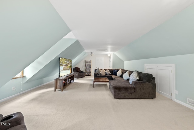 carpeted living room featuring vaulted ceiling and baseboards