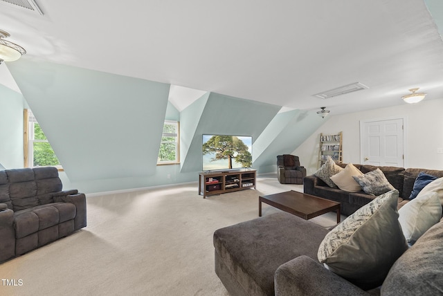 carpeted living area with plenty of natural light, lofted ceiling, and baseboards