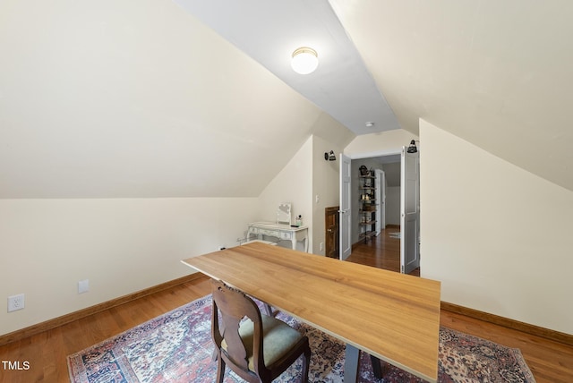 office space with lofted ceiling, wood finished floors, and baseboards