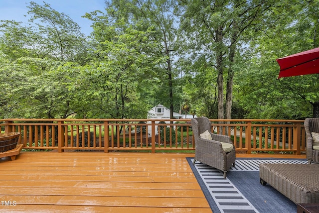 wooden deck featuring view of wooded area