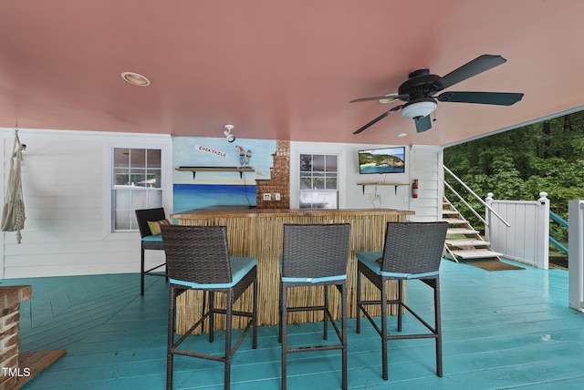 wooden deck with a ceiling fan