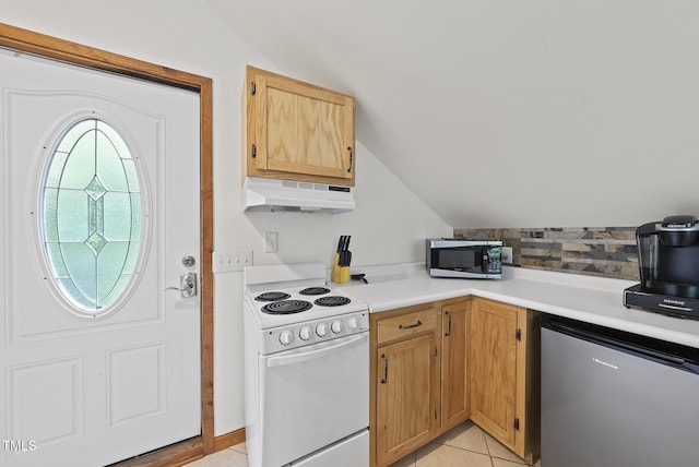 kitchen with white electric range, under cabinet range hood, vaulted ceiling, stainless steel microwave, and fridge