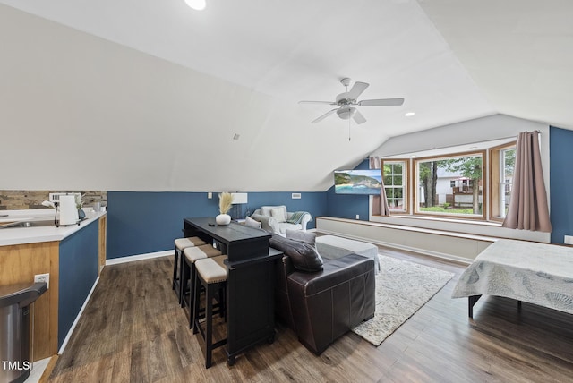 living room with dark wood finished floors, baseboards, vaulted ceiling, and ceiling fan