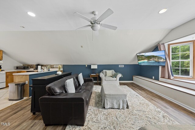 living room featuring lofted ceiling, light wood-style floors, a ceiling fan, recessed lighting, and baseboards
