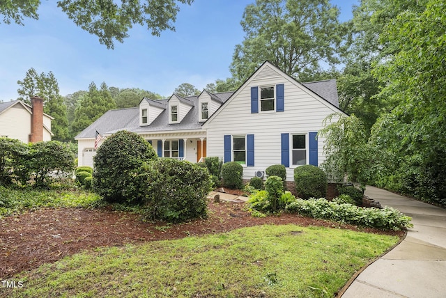cape cod-style house with a garage and a shingled roof