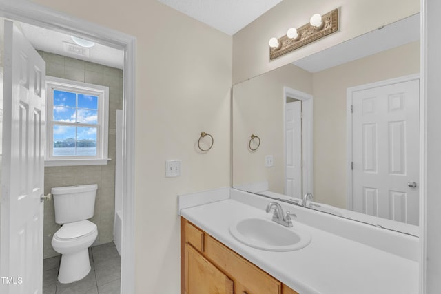 full bath featuring tile patterned floors, vanity, toilet, a shower, and a tub to relax in