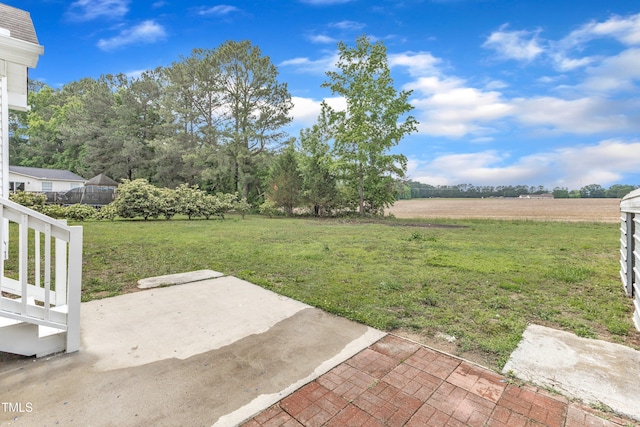 view of grassy yard with a patio