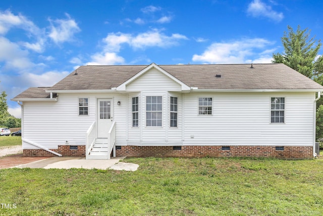 rear view of house featuring crawl space, entry steps, a yard, and a shingled roof