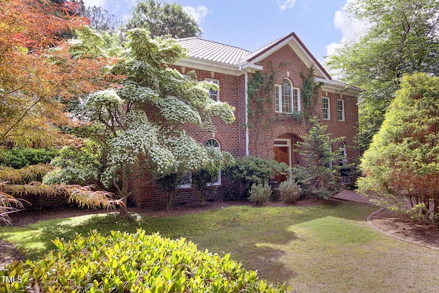 107 Silo Dr, Chapel Hill, NC 27514 - view of side of home featuring brick siding, a lawn, and metal roof