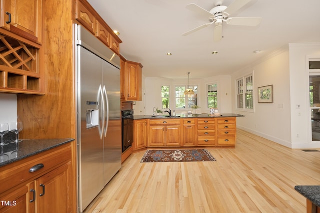 107 Silo Dr, Chapel Hill, NC 27514 - kitchen with built in fridge, a peninsula, brown cabinets, light wood-style floors, and crown molding