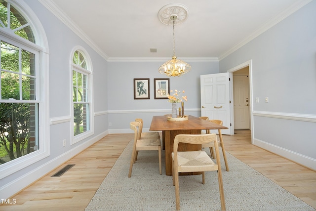 107 Silo Dr, Chapel Hill, NC 27514 - dining space featuring light wood-style flooring, crown molding, a chandelier, and baseboards
