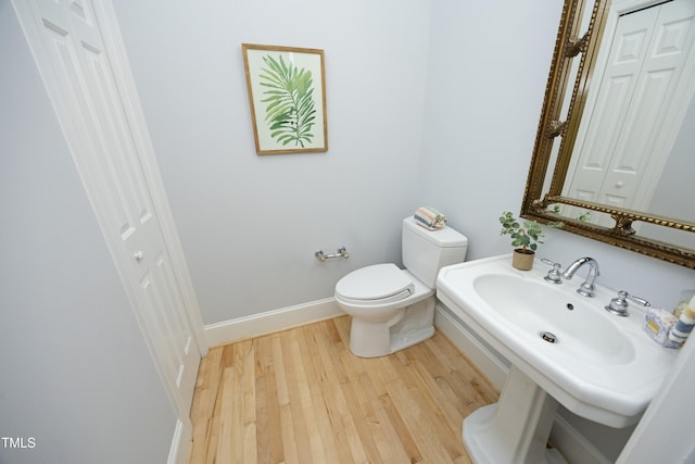 107 Silo Dr, Chapel Hill, NC 27514 - bathroom featuring wood finished floors, toilet, a sink, baseboards, and a closet