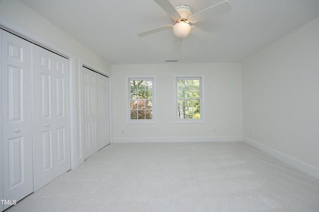 107 Silo Dr, Chapel Hill, NC 27514 - unfurnished bedroom with two closets, light carpet, and baseboards