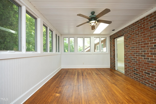 107 Silo Dr, Chapel Hill, NC 27514 - unfurnished sunroom featuring brick wall, wood-type flooring, baseboards, and wooden ceiling
