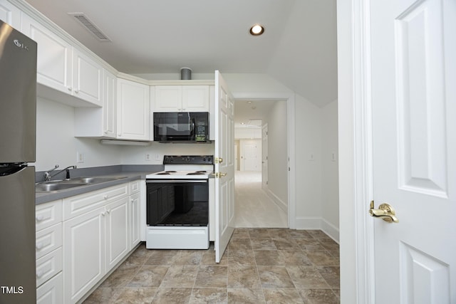 107 Silo Dr, Chapel Hill, NC 27514 - kitchen with black microwave, white electric range, freestanding refrigerator, a sink, and white cabinets