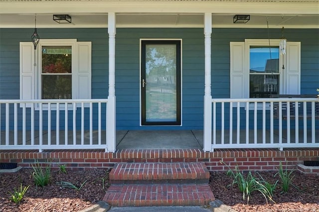 view of exterior entry with covered porch
