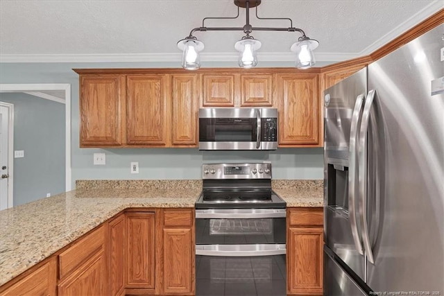 kitchen featuring appliances with stainless steel finishes, crown molding, brown cabinetry, and light stone counters