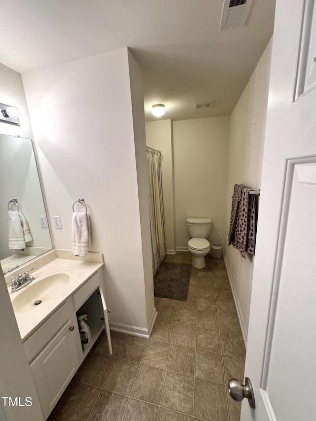 bathroom with toilet, vanity, baseboards, tile patterned flooring, and curtained shower