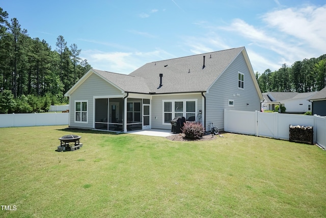 2501 Impulsion Dr, New Hill, NC 27562 - rear view of property featuring a sunroom, an outdoor fire pit, roof with shingles, and a patio