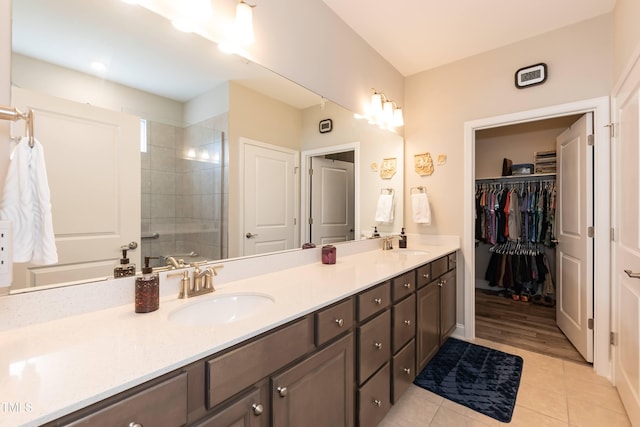 2501 Impulsion Dr, New Hill, NC 27562 - full bath with double vanity, tile patterned flooring, tiled shower, and a walk in closet
