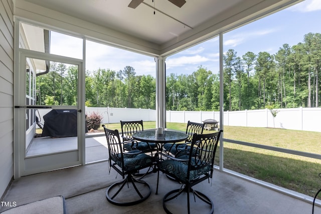 2501 Impulsion Dr, New Hill, NC 27562 - sunroom featuring a ceiling fan, outdoor dining area, and view of scattered trees