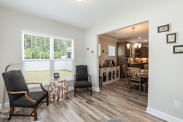2501 Impulsion Dr, New Hill, NC 27562 - living area with a chandelier, light wood-style floors, and baseboards