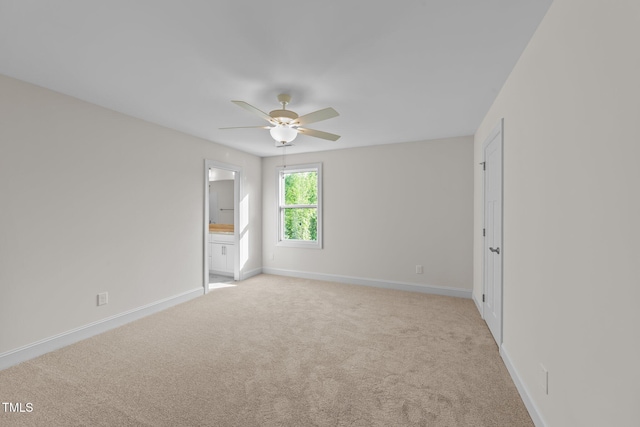 525 Allesandra Dr, Clayton, NC 27527 - unfurnished bedroom with baseboards, light carpet, ensuite bath, and a ceiling fan