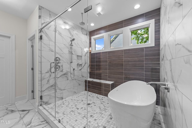 525 Allesandra Dr, Clayton, NC 27527 - bathroom featuring tile walls, a stall shower, a freestanding bath, recessed lighting, and marble finish floors