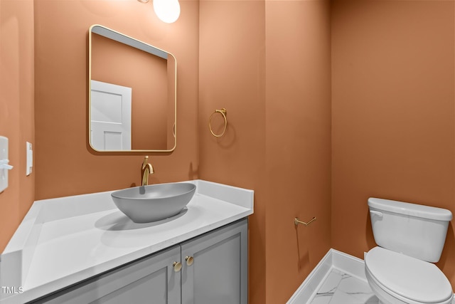 525 Allesandra Dr, Clayton, NC 27527 - half bathroom with marble look tile flooring, vanity, toilet, and baseboards
