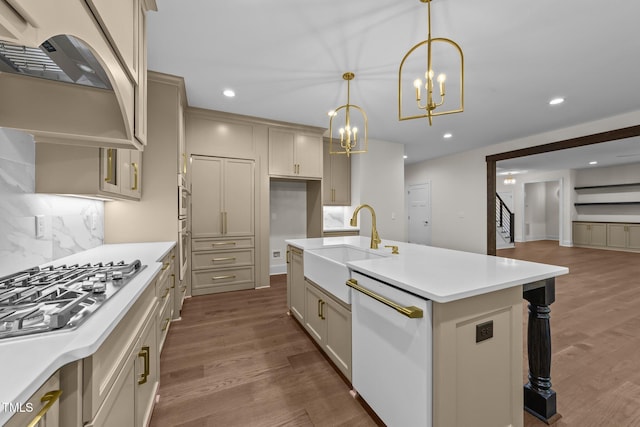 525 Allesandra Dr, Clayton, NC 27527 - kitchen with a sink, dishwasher, range hood, a chandelier, and backsplash